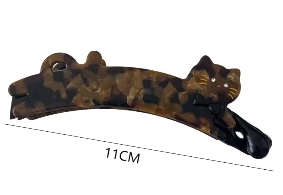 Hårklämma (bananklämma)-utsträckt katt, finns i tre olika varianter
